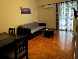 Apartment, City View | Living area | 32-inch flat-screen TV with digital channels