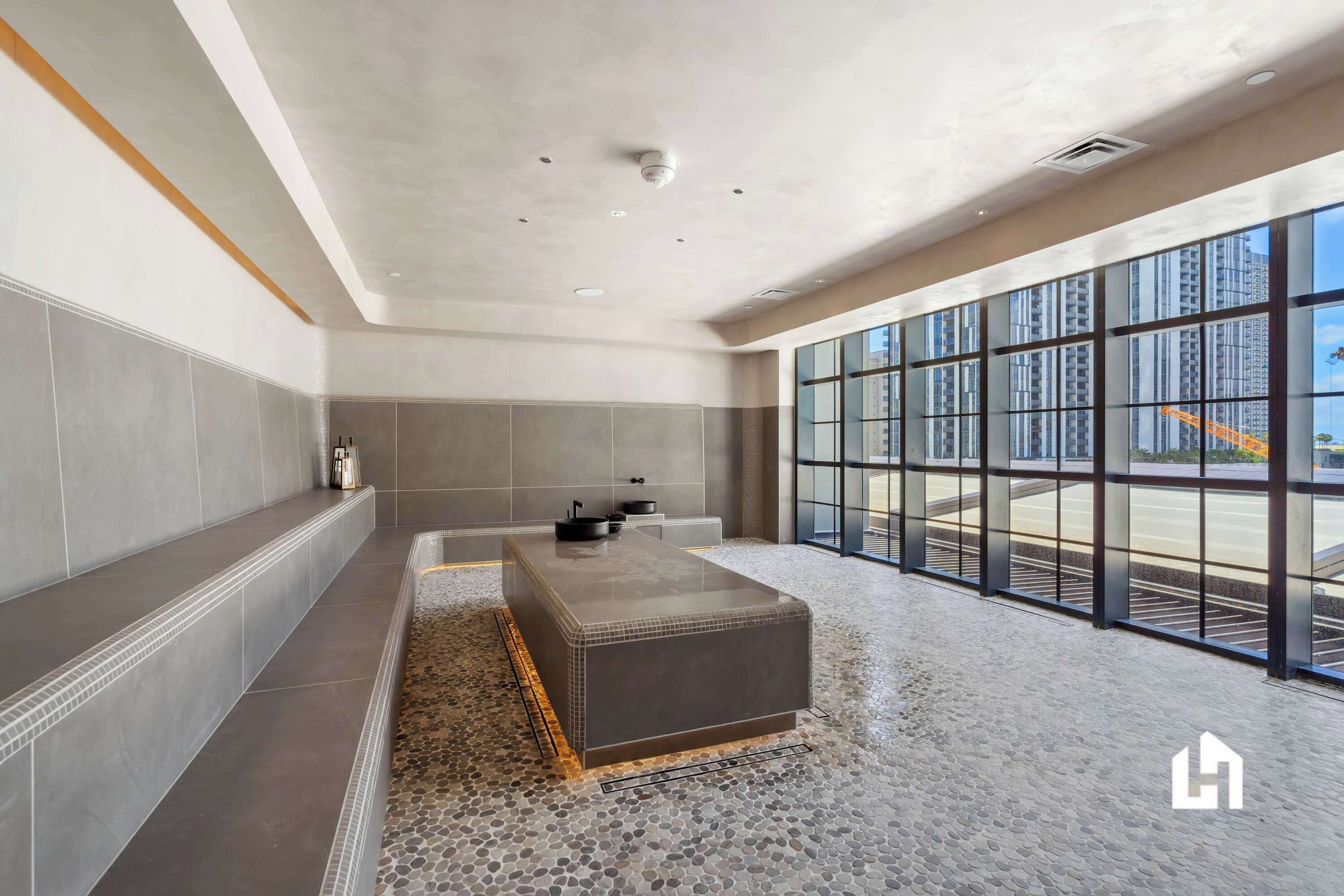 A luxurious spa-like room with a unique pebbled floor