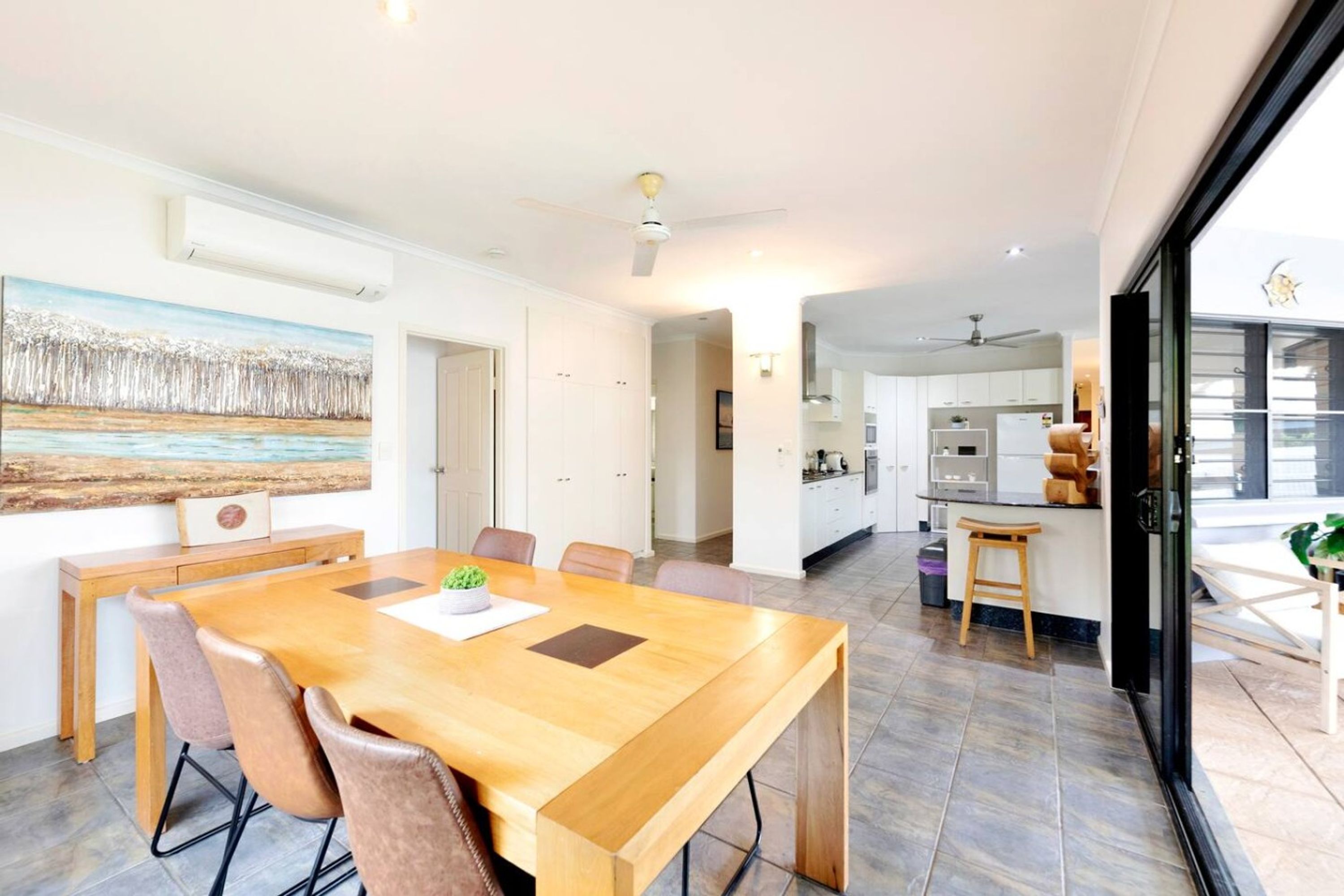 A modern kitchen with white cabinets and a central island.