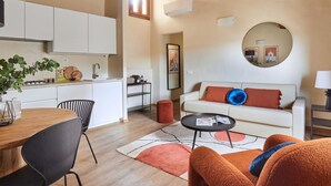 A modern living space with a kitchen, dining area, and seating area. - Casa Negroni, ancient house in front of medieval walls (Firenze)