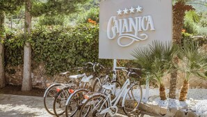 A sign for Cianica Resort surrounded by greenery and bicycles. - Hotiday Apartments Cefalù (Cefalù)