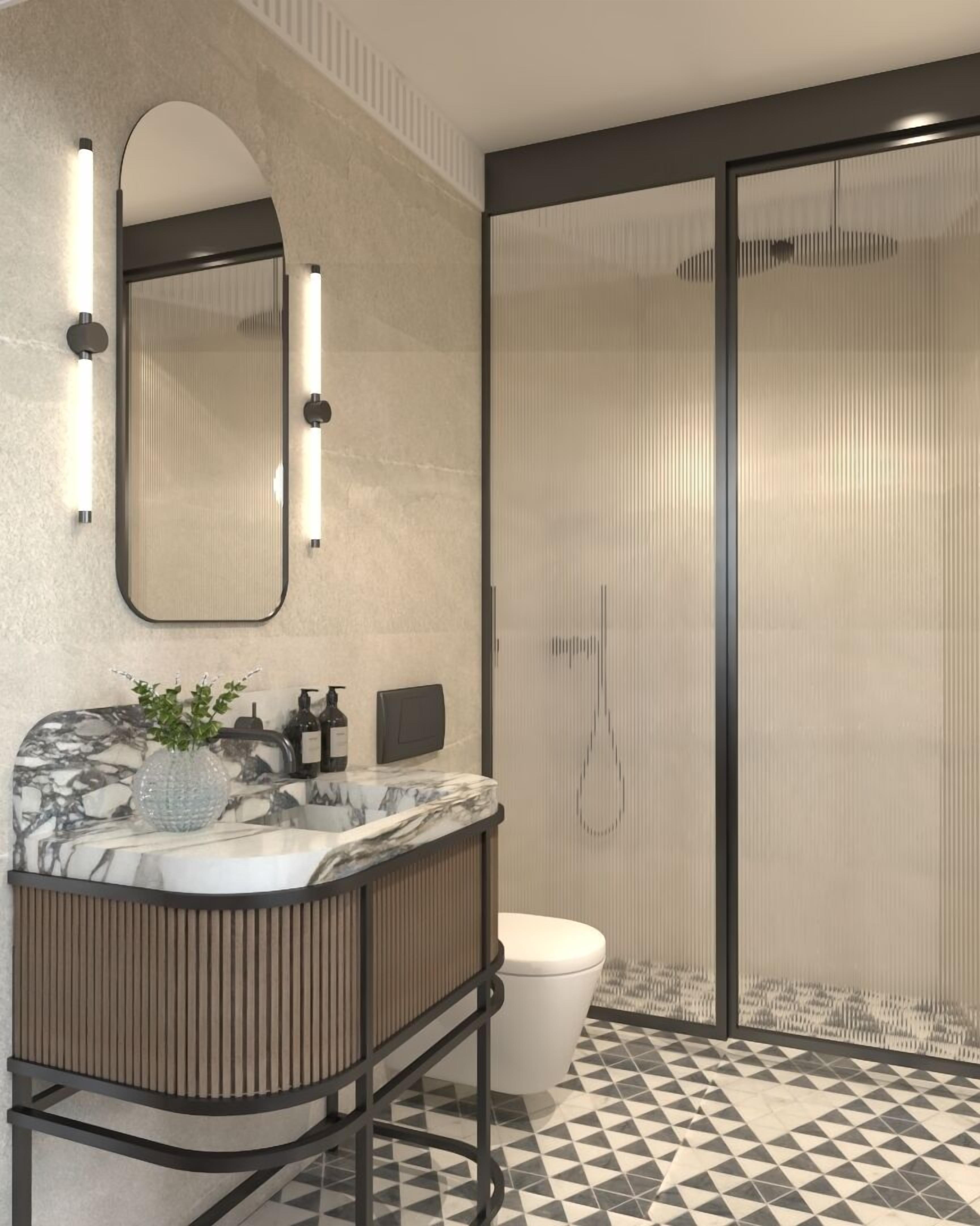 Un baño moderno con un lavabo de mármol, un espejo grande y una ducha con puerta de cristal.