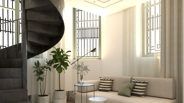 Un salon moderne avec un canapé, une table basse et un escalier en colimaçon.
