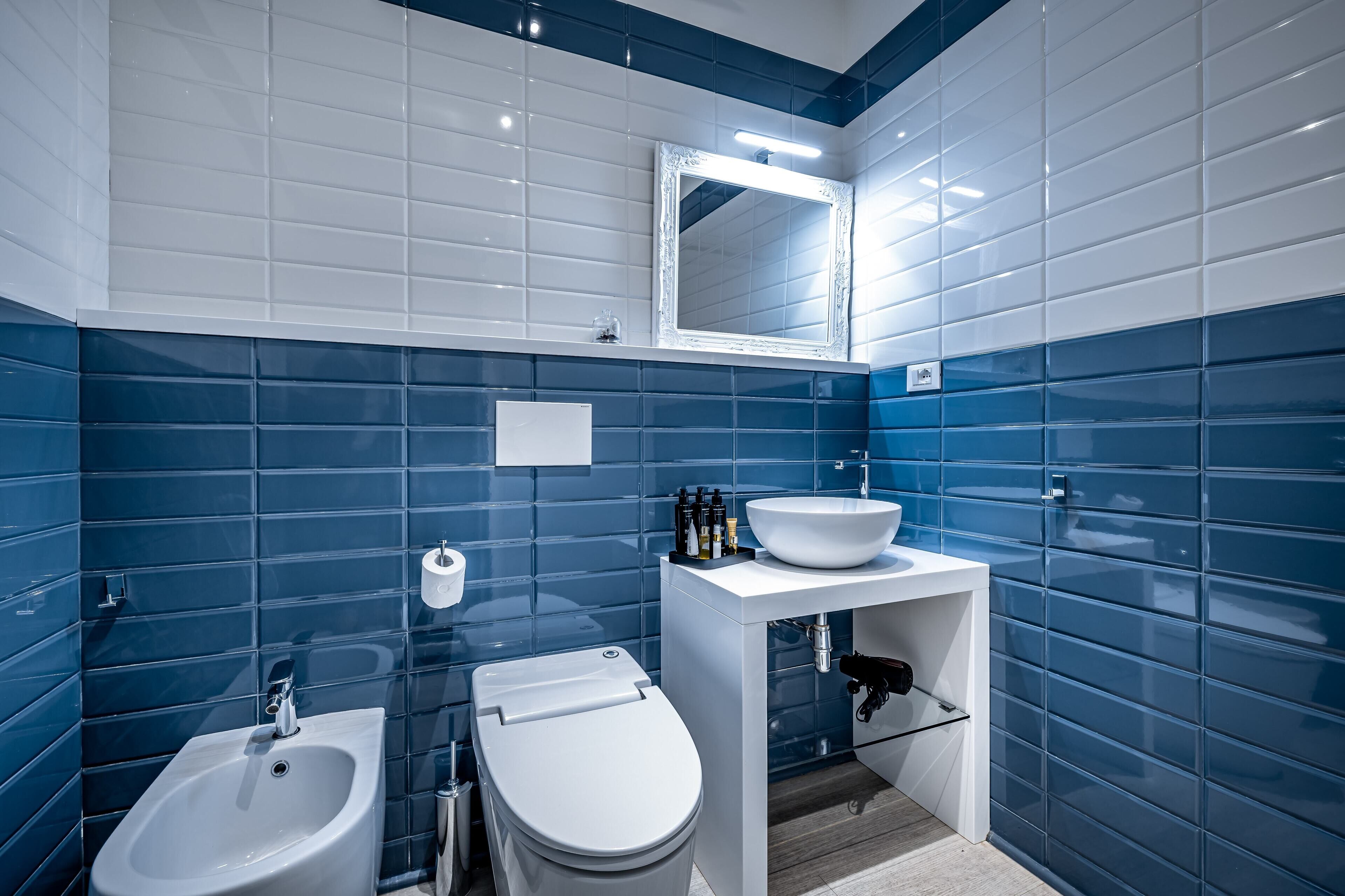 Un baño moderno con bidé, inodoro y lavamanos.