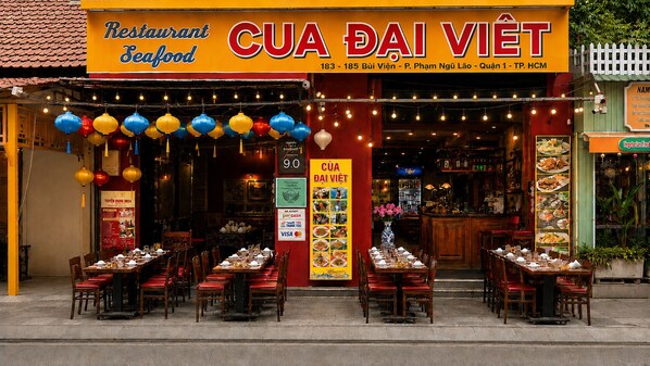 A restaurant named CUA DAI VIET with outdoor seating and a sign indicating it accepts cash and credit cards. - The Rice Hotel & Tour - 191 Bui Vien (Ho Chi Minh City)