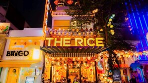 A restaurant named 'THE RICE' with outdoor seating and a signboard. - The Rice Hotel & Tour - 191 Bui Vien (Ho Chi Minh City)