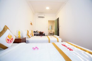 A hotel room with two beds, a desk, and a bathroom. - The Rice Hotel & Tour - 191 Bui Vien (Ho Chi Minh City)