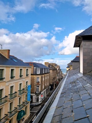 A hotel with a traditional European architectural style, featuring a stone facade, multiple windows, and a visible entrance. - Charming seaside apartment (Dinard)