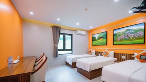 A hotel room with two beds, a wooden desk, a chair, a window with curtains, and wall-mounted air conditioning. - Ha Giang City Hostel (Ha Giang 1)