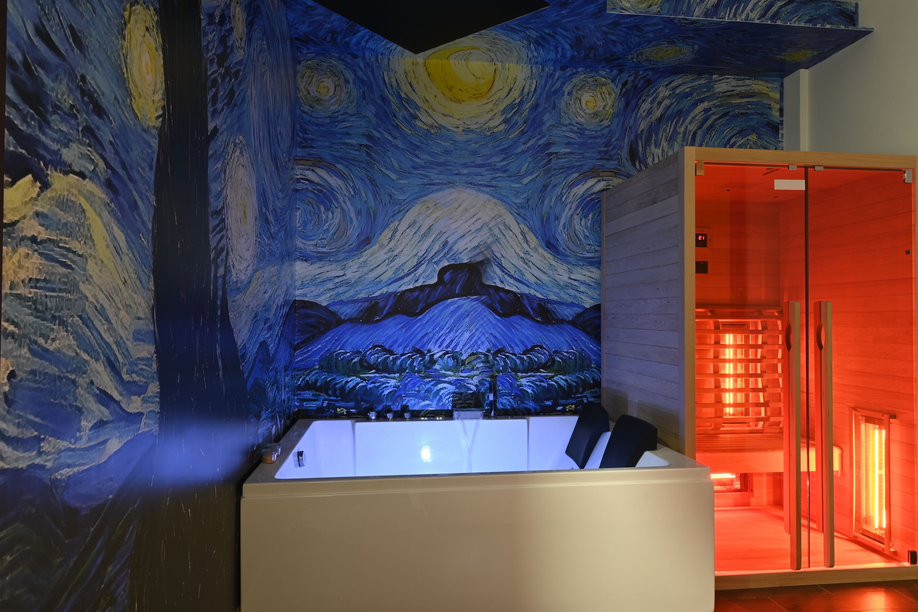 A room with a large painting on the wall, a bathtub, and a wooden structure with red lighting.