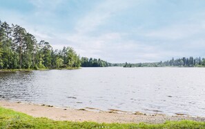 Escape to a serene lakeside haven surrounded by lush forest.