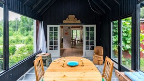 Une table de salle à manger en bois, avec des chaises, une assiette bleue et un élément décoratif au centre.