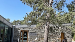 A stone building with a sign reading 'naturum Trollskogen.' - Nice cottage located in the north of Öland next to Byxelkrok | SE04024 (Byxelkrok)