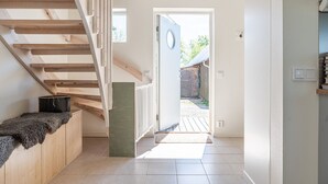 A staircase leading to a room with a view of a garden.