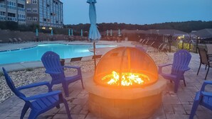 A poolside area with a fire pit and lounge chairs. - Top-floor Balcony & Serene Views: Huddleston Condo (Huddleston)