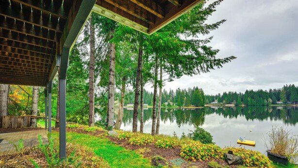 A covered outdoor area with a view of a lake and trees. - Lakefront Gem w/ Deck & Grill in Shelton (Shelton)