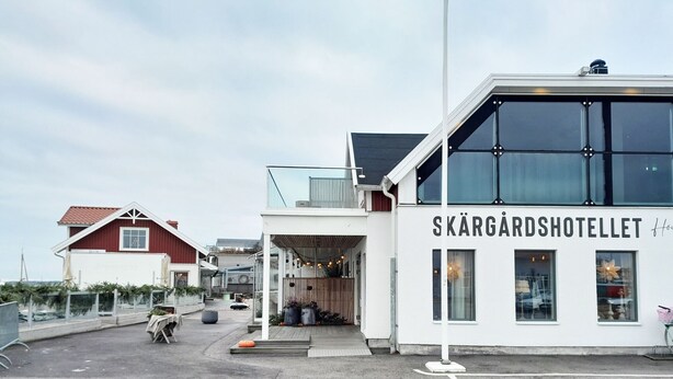 Un hotel con fachada moderna, un acceso cubierto y un cartel que dice 'SKÄRGÅRDHOTELLET'.