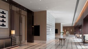 A modern hotel lobby with a marble floor, a reception desk, and a seating area. - Dangkou Ancient Town Hotel Wuxi - Mgallery Collection (Wuxi)