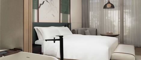 A modern bedroom with a bed, bedside table, and a large bathtub.