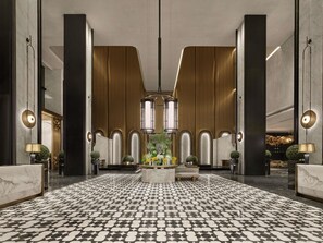 A spacious lobby with a patterned floor, a central seating area, and modern lighting fixtures. - Fairmont Xiamen  (Xiamen)