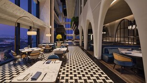 A modern hotel lobby with a checkered floor, seating areas, and large windows offering city views. - Fairmont Xiamen  (Xiamen)