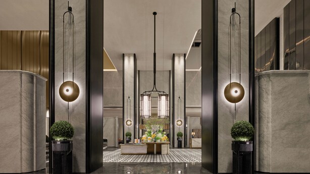 A modern lobby with a central reception desk, tall columns, and a chandelier. - Fairmont Xiamen  (Xiamen)