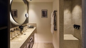 A modern bathroom with a large mirror, three sinks, a shower, and a towel rack. - L'Isle de Leos Hotel & Spa - MGallery Collection (L'Isle-sur-la-Sorgue)