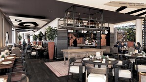 A modern restaurant interior with a central bar, dining tables, and chairs. - L'Isle de Leos Hotel & Spa - MGallery Collection (L'Isle-sur-la-Sorgue)