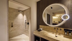 A bathroom with a shower, a vanity with a mirror, and a sink. - L'Isle de Leos Hotel & Spa - MGallery Collection (L'Isle-sur-la-Sorgue)