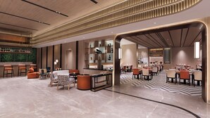 A modern hotel lobby with a bar area, seating arrangements, and a patterned floor. - Mercure Kathmandu Sukedhara Heights (Kathmandu)