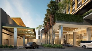 A modern building with a covered entrance, palm trees, and cars parked in front. - Mercure Madiun (Madiun)