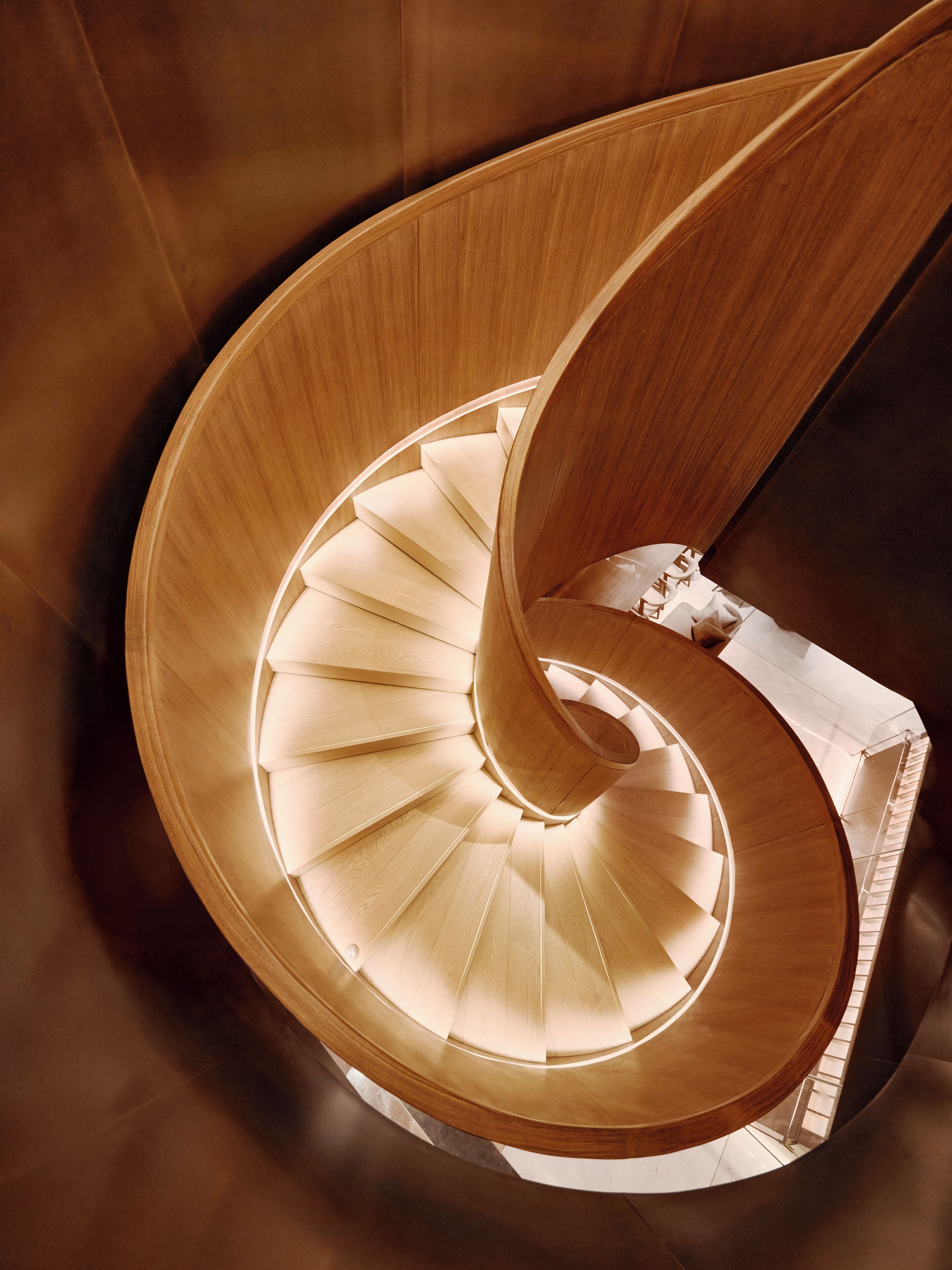 A spiral staircase with wooden steps and a central column.