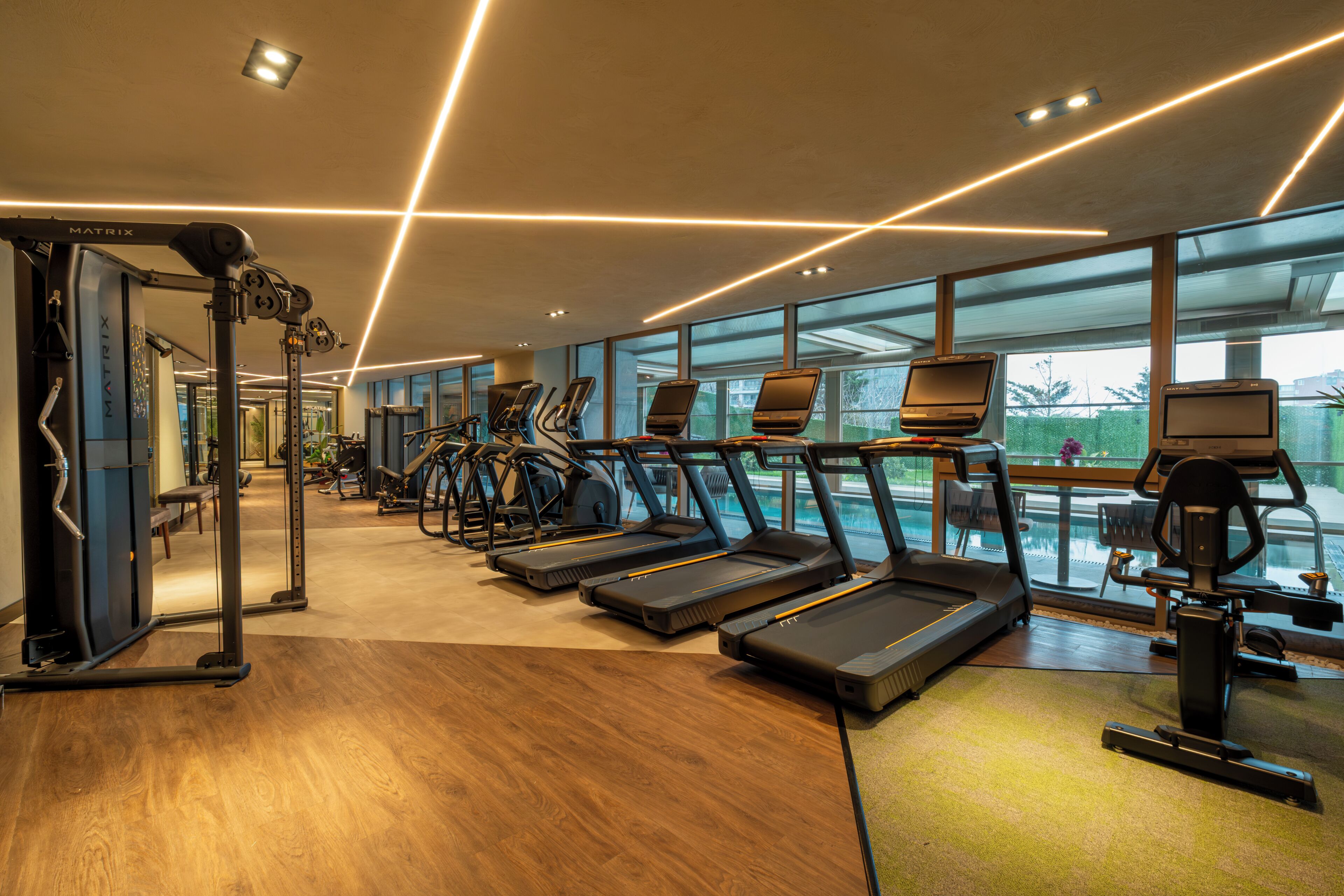 A gym with treadmills, exercise bikes, and weight machines.