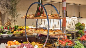 A buffet with various food items and a decorative centerpiece. - Novotel Istanbul Bomonti (Istanbul)