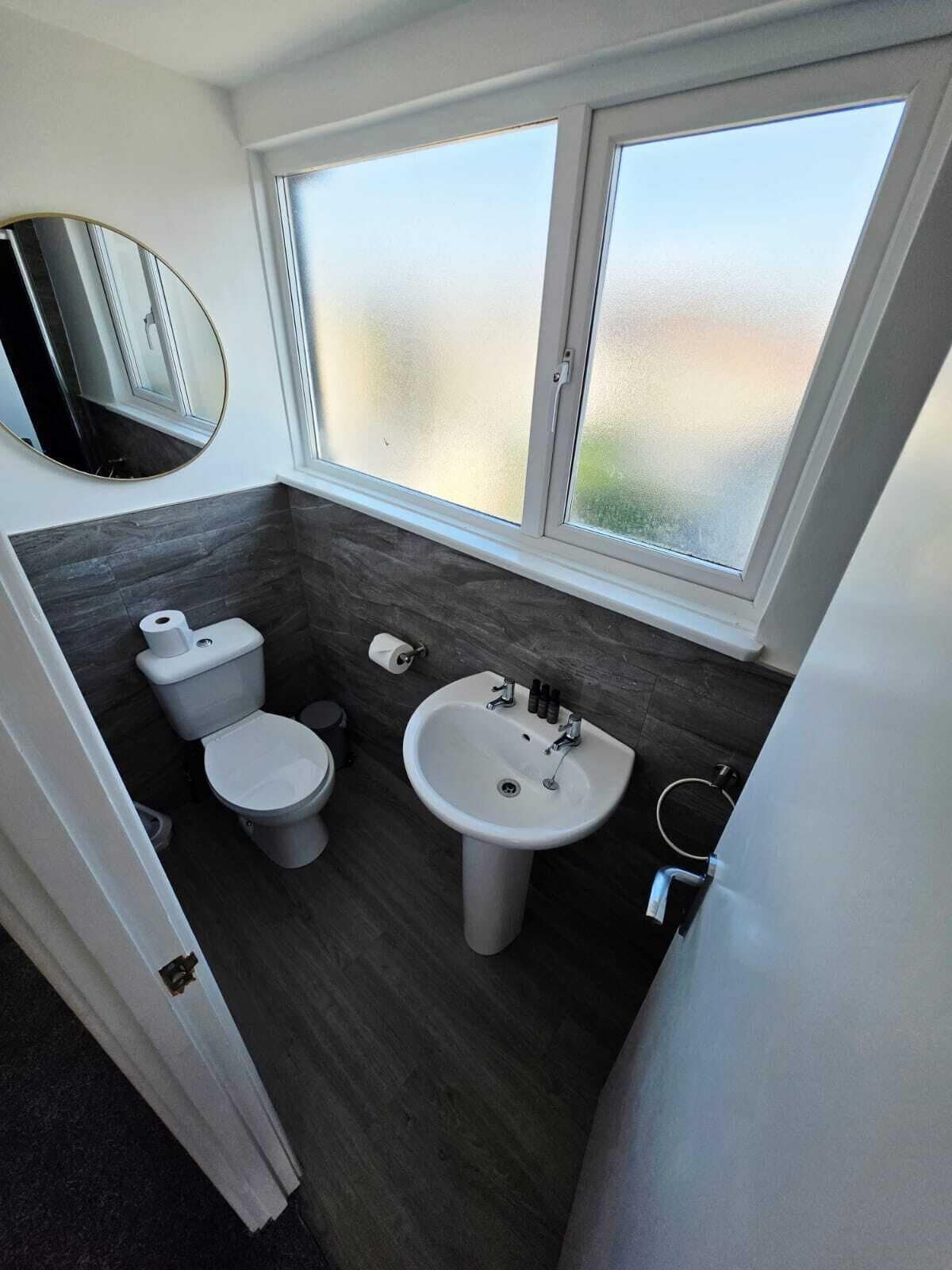 A modern bathroom with a toilet, bidet, and sink.