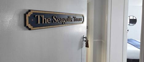 Un pasillo con una puerta que dice 'The Seagull's Tower'.
