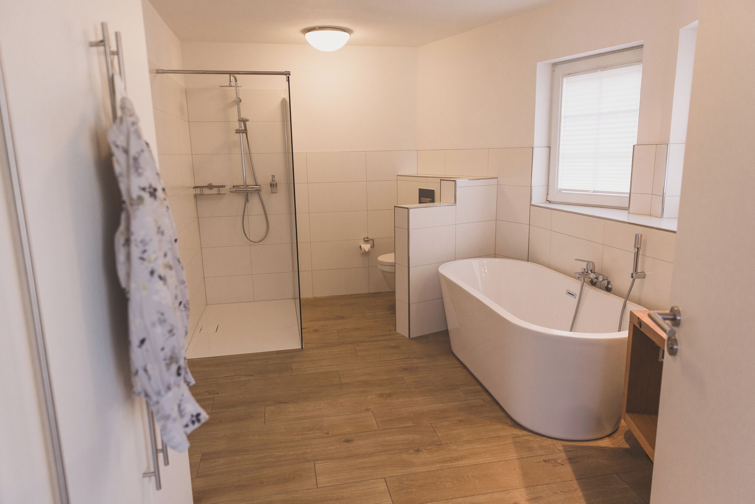 A bathroom with a shower, toilet, and bathtub.