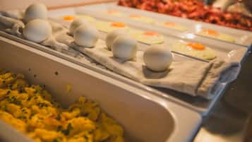 A buffet with various food items including eggs, scrambled eggs, and other dishes.