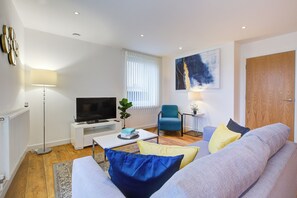 Comfort Apartment, Balcony, City View | Living area | 32-cm flat-screen TV with digital channels