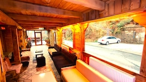A wooden interior with benches, a tiled floor, and a view of a road outside. - Rubaşi Butik Otel & Restoran (Findikli)