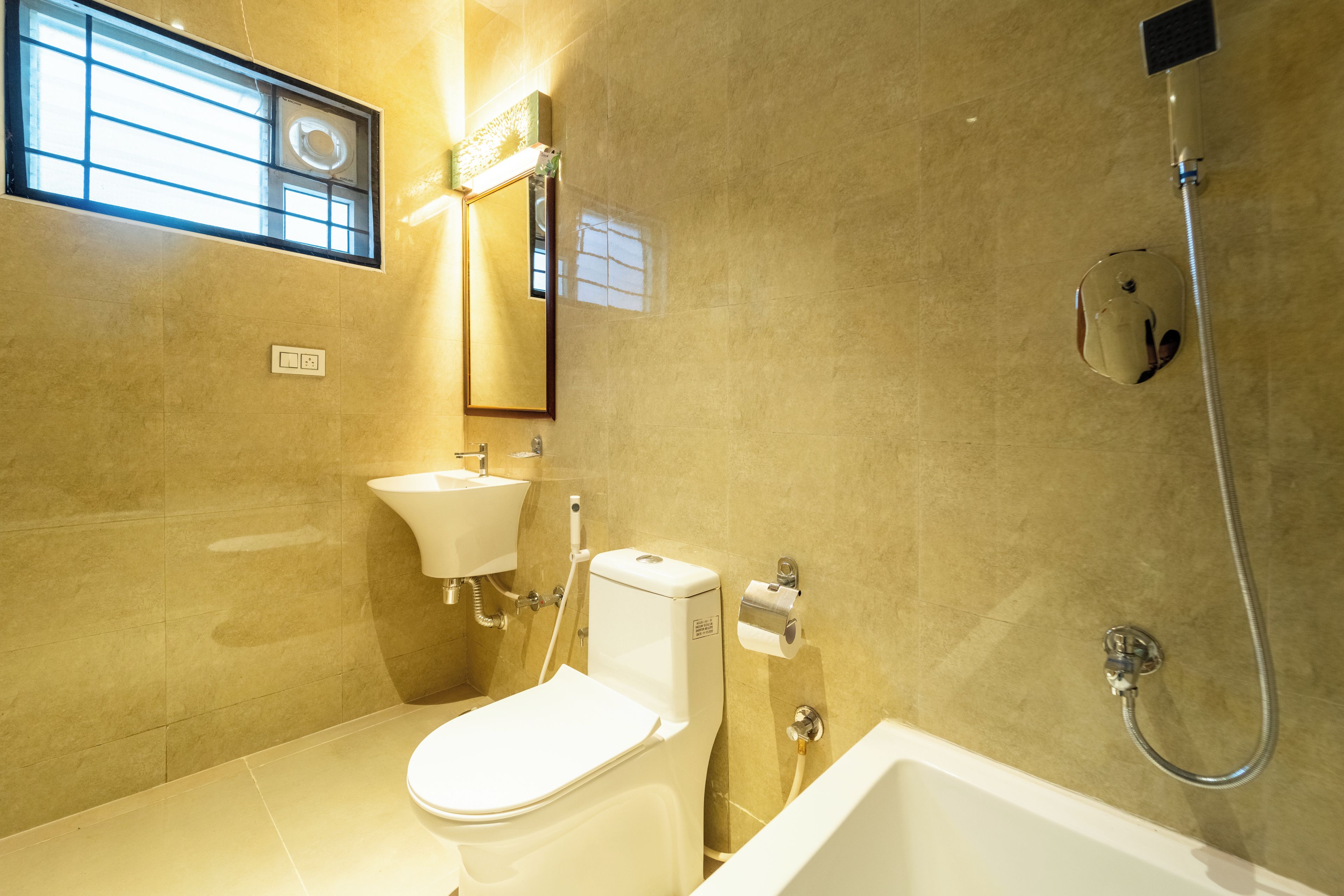 A bathroom with a toilet, sink, and shower.