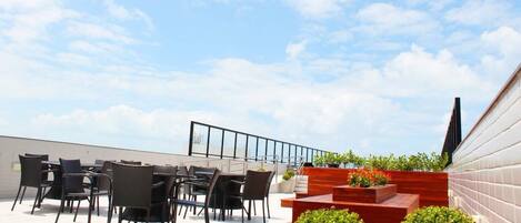 An outdoor patio area with a seating arrangement and a view of the sky.