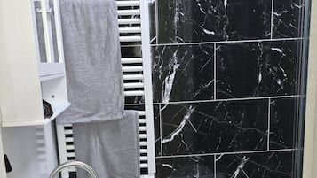 Shower, towels, soap, toilet paper