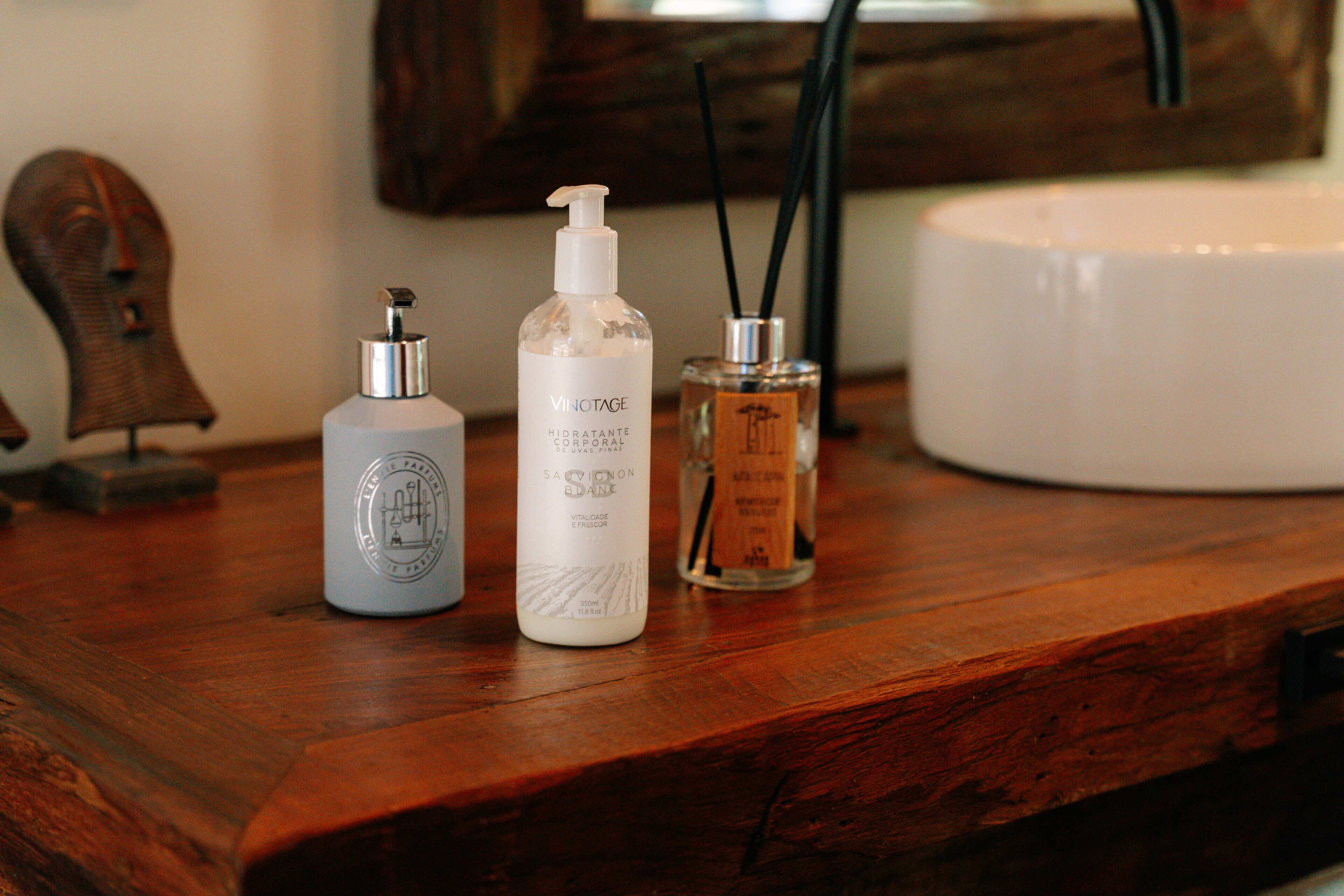 A wooden surface with three bottles of personal care products.