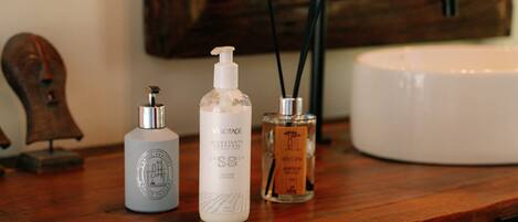 A wooden surface with three bottles of personal care products.
