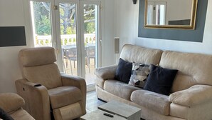 A modern living room with a beige sofa, a recliner, and a coffee table. - Villa with heated pool and private padel court (Pinos de Alhaurín)