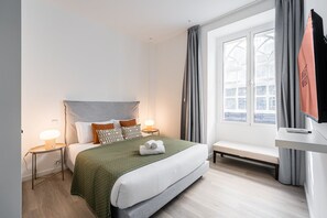 Relax in a stylish room with a large bed, bedside tables, and a flat-screen TV.