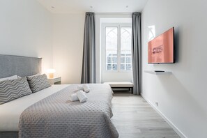 Tabla de planchar con plancha, internet y ropa de cama