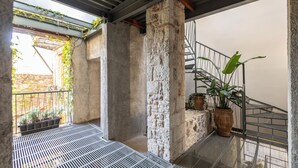 A balcony with a metal railing, stone columns, and potted plants. - Asomaton by Oniro (Athens)