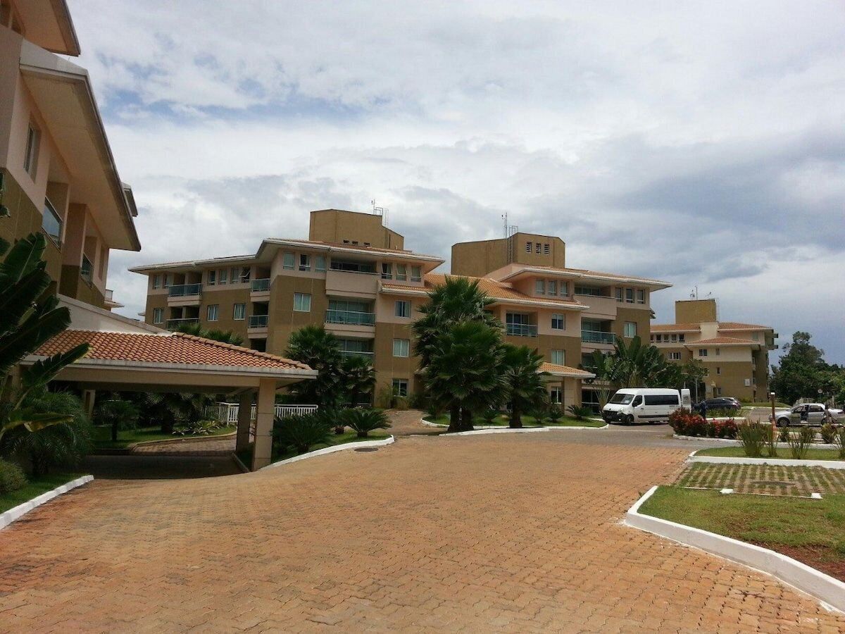 A multi-story hotel with a covered entrance and a paved driveway.